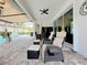 Relaxing poolside patio with wicker seating and retractable awning at 15503 Corona Del Mar Dr, Wimauma, FL 33598
