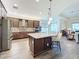 Spacious kitchen features a large island, stainless steel appliances, and plenty of cabinet storage at 15503 Corona Del Mar Dr, Wimauma, FL 33598
