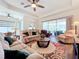 Open living room with comfortable seating and a large area rug at 15503 Corona Del Mar Dr, Wimauma, FL 33598