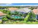 Aerial view of a luxurious pool and spa with tropical landscaping at 15503 Corona Del Mar Dr, Wimauma, FL 33598