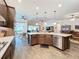 Open kitchen design features a large island, stainless steel appliances, and ample counter space at 15503 Corona Del Mar Dr, Wimauma, FL 33598