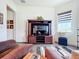 Gathering room with a large TV, comfortable seating, and built-in entertainment center at 15503 Corona Del Mar Dr, Wimauma, FL 33598