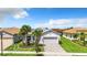 Single-Gathering home with a two-car garage and landscaped yard at 15503 Corona Del Mar Dr, Wimauma, FL 33598