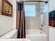 Clean bathroom with tub, shower, and updated fixtures at 15503 Corona Del Mar Dr, Wimauma, FL 33598