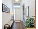 Light and spacious entryway with wood-look tile floors and a bench at 15503 Corona Del Mar Dr, Wimauma, FL 33598