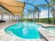 Screened pool and spa with covered patio and retractable awning at 15503 Corona Del Mar Dr, Wimauma, FL 33598