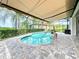 Lush pool area with covered patio, spa, and retractable awning at 15503 Corona Del Mar Dr, Wimauma, FL 33598