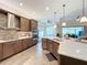 Large kitchen with stainless steel appliances, an island, and dark wood cabinetry at 15503 Corona Del Mar Dr, Wimauma, FL 33598