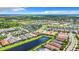 Aerial view showcasing a community with homes, waterways, and tennis courts at 15503 Corona Del Mar Dr, Wimauma, FL 33598