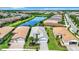 Aerial view of community with single-Gathering homes and a lake at 15503 Corona Del Mar Dr, Wimauma, FL 33598