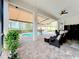 Inviting pool area with covered patio, comfortable seating, and retractable awning at 15503 Corona Del Mar Dr, Wimauma, FL 33598