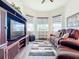Relaxing Gathering room featuring comfy seating, built-in shelving, and large TV at 15503 Corona Del Mar Dr, Wimauma, FL 33598