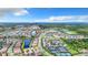 Aerial view of a large residential community with waterways and tennis courts at 15503 Corona Del Mar Dr, Wimauma, FL 33598