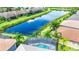 Aerial view of a home with a private pool and lake access at 15503 Corona Del Mar Dr, Wimauma, FL 33598