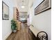 Bright and airy entryway with wood flooring, built-in shelving, and a bench at 15503 Corona Del Mar Dr, Wimauma, FL 33598