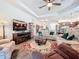 Open concept living room with comfortable seating and a large TV at 15503 Corona Del Mar Dr, Wimauma, FL 33598