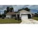 One story house with white siding, brown brick accents, and a two-car garage at 9920 Saint Charles Ct, New Port Richey, FL 34655