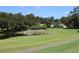 Golf course with pond and home in background at 6536 Northlake Dr, Zephyrhills, FL 33542