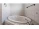 Bathroom with corner garden tub and tile flooring at 6536 Northlake Dr, Zephyrhills, FL 33542