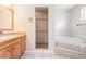 Bathroom with tiled shower and bathtub at 6536 Northlake Dr, Zephyrhills, FL 33542