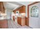 Kitchen features wood cabinets and tile floors at 6536 Northlake Dr, Zephyrhills, FL 33542