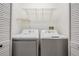 Laundry room with washer, dryer, and shelving at 6536 Northlake Dr, Zephyrhills, FL 33542