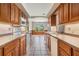 Kitchen with light oak cabinets, tile floors, and stainless steel appliances at 6536 Northlake Dr, Zephyrhills, FL 33542