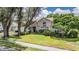 Single-story house with a landscaped lawn and driveway at 6536 Northlake Dr, Zephyrhills, FL 33542