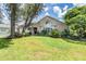 House exterior with lush landscaping and large trees at 6536 Northlake Dr, Zephyrhills, FL 33542