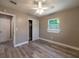 Bright bedroom featuring wood-look floors and built-in closet at 6017 Dublin Dr, New Port Richey, FL 34653