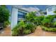 Exterior of a condo building with landscaping and a walkway at 1555 Tarpon Center Dr # 136, Venice, FL 34285