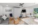 Comfortable living room with a Murphy bed and access to a patio at 1555 Tarpon Center Dr # 136, Venice, FL 34285