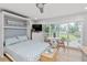Bedroom with Murphy bed, and sliding glass doors at 1555 Tarpon Center Dr # 136, Venice, FL 34285