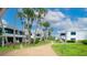 Landscaped grounds with palm trees and walking paths at 1555 Tarpon Center Dr # 136, Venice, FL 34285