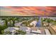 Aerial view of community near the water at sunset at 1555 Tarpon Center Dr # 136, Venice, FL 34285