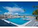 Inviting community pool area with ample lounge chairs and ocean views at 1555 Tarpon Center Dr # 136, Venice, FL 34285