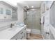 Modern bathroom with white vanity, walk-in shower, and tile flooring at 1555 Tarpon Center Dr # 136, Venice, FL 34285