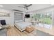 Bright bedroom with a Murphy bed, and sliding glass doors leading to a patio at 1555 Tarpon Center Dr # 136, Venice, FL 34285
