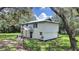 Two-story house with fenced yard and mature trees at 6902 E 29Th Ave, Tampa, FL 33619
