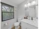 Bathroom with white vanity, toilet and marble shower at 6902 E 29Th Ave, Tampa, FL 33619