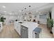 Modern kitchen with a large marble island, stainless steel appliances, and stylish pendant lighting at 6902 E 29Th Ave, Tampa, FL 33619