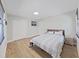 Spacious bedroom with gray bedding and wood flooring at 6902 E 29Th Ave, Tampa, FL 33619