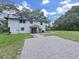 Two-story house with a paved driveway at 6902 E 29Th Ave, Tampa, FL 33619