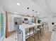 Open concept kitchen boasts a large marble island with seating and stylish pendant lights at 6902 E 29Th Ave, Tampa, FL 33619