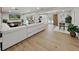 Open concept living room with a large sectional sofa and hardwood floors at 6902 E 29Th Ave, Tampa, FL 33619