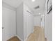 Bright hallway with light gray walls and wood-look flooring at 6902 E 29Th Ave, Tampa, FL 33619