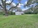 Large backyard with a house and trees at 6902 E 29Th Ave, Tampa, FL 33619