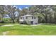 Two-story house with a large backyard, surrounded by trees at 6902 E 29Th Ave, Tampa, FL 33619
