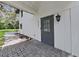 Inviting front entrance with a gray door and a brick walkway at 6902 E 29Th Ave, Tampa, FL 33619