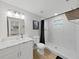 Clean bathroom with white vanity, marble shower, and hexagon tile flooring at 6902 E 29Th Ave, Tampa, FL 33619
